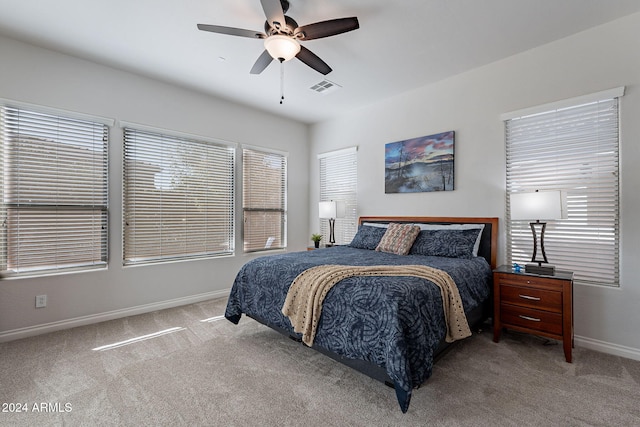 bedroom with ceiling fan and light carpet