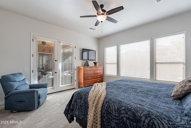 bedroom with ceiling fan, access to exterior, light colored carpet, french doors, and multiple windows