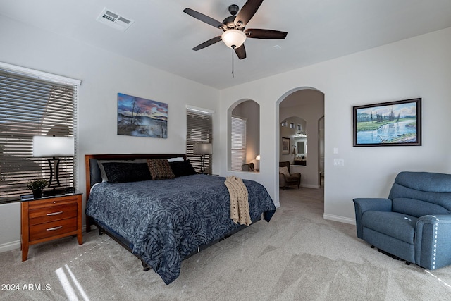 bedroom with light carpet and ceiling fan