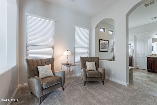 living area with light carpet