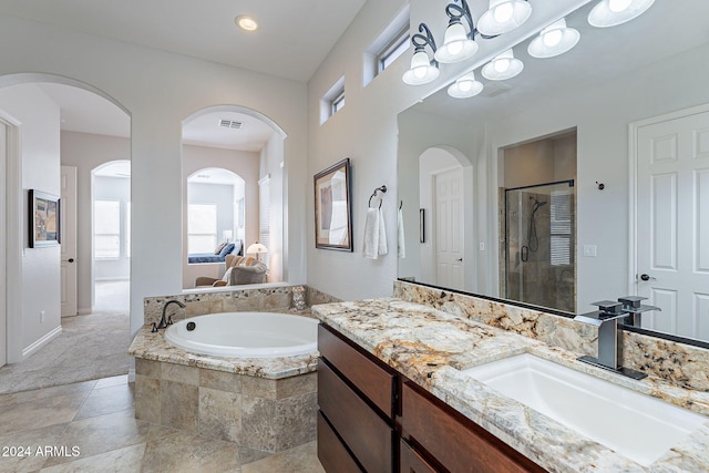 bathroom featuring separate shower and tub and vanity