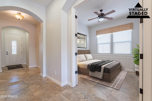 entrance foyer with ceiling fan