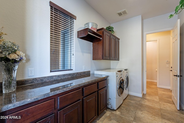 clothes washing area featuring cabinets and independent washer and dryer