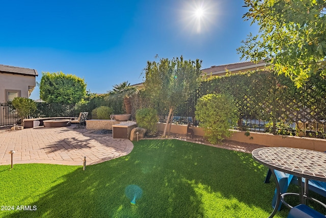 view of yard with an outdoor fire pit and a patio