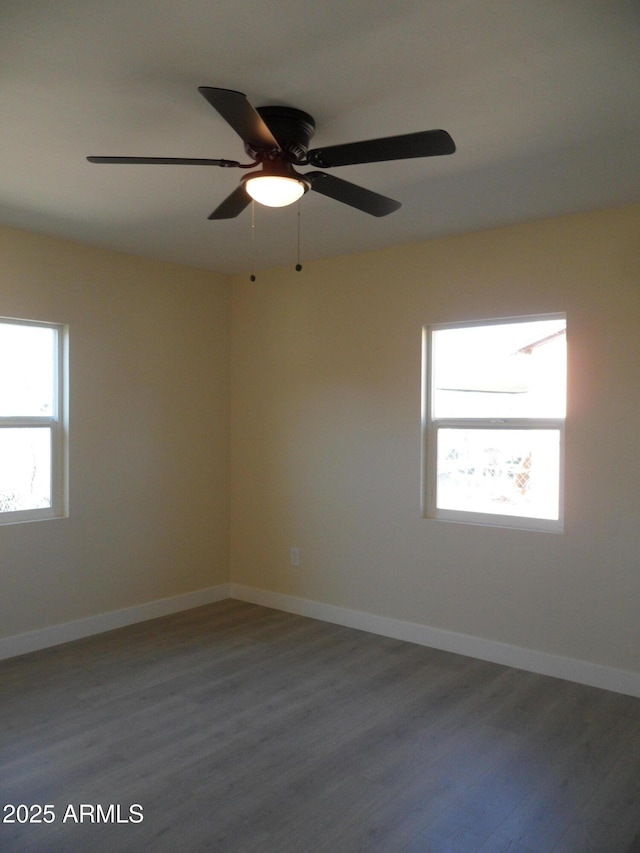 empty room with ceiling fan and wood-type flooring