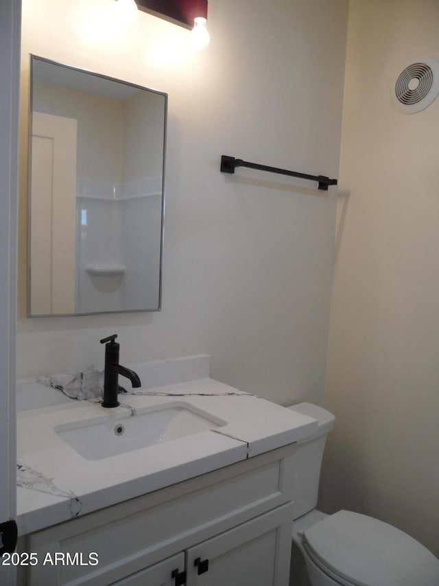 bathroom with vanity and toilet