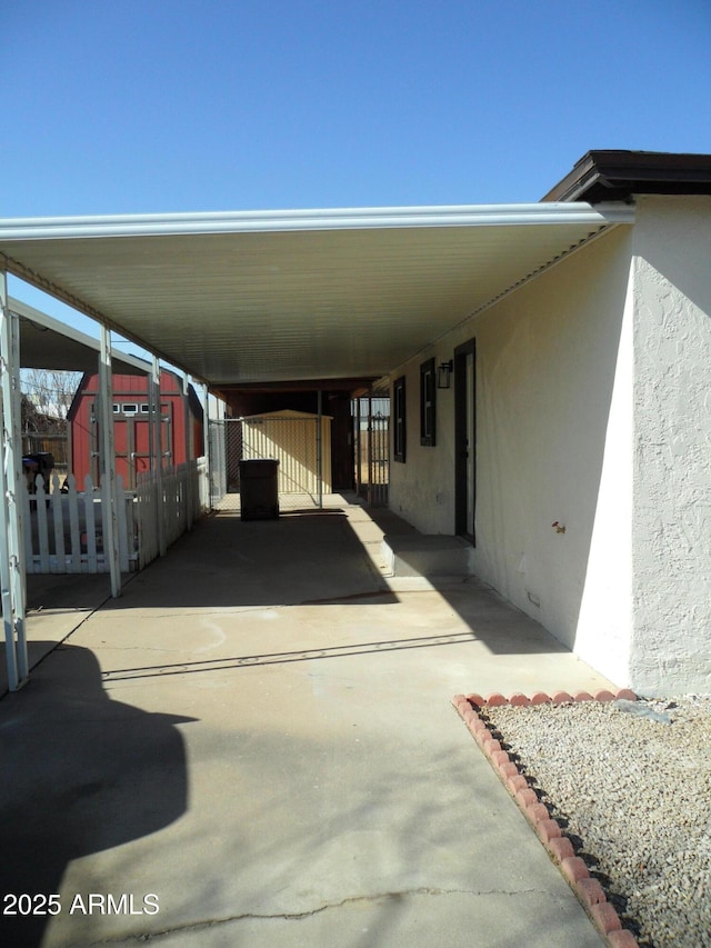 view of car parking featuring a carport and electric panel