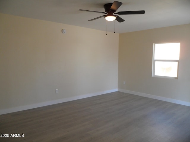 unfurnished room with ceiling fan and dark hardwood / wood-style floors