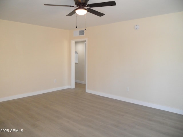 empty room with wood-type flooring and ceiling fan