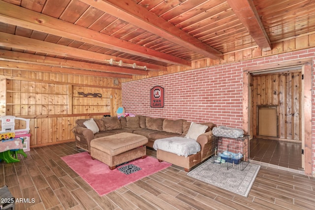 118 E 10th St, Casa Grande, AZ 85122 - living room featuring beamed ceiling, wooden ceiling, wood finish floors, wooden walls, and brick wall