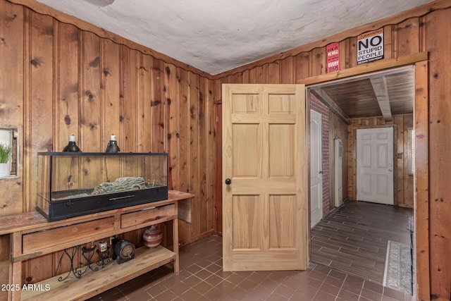 118 E 10th St, Casa Grande, AZ 85122 - hall featuring wooden walls and dark tile patterned floors