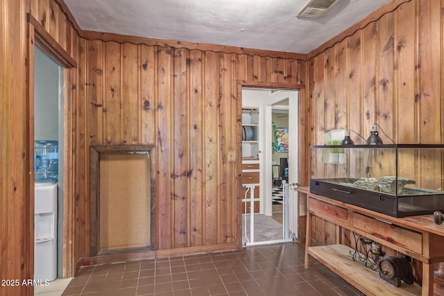 118 E 10th St, Casa Grande, AZ 85122 - hall with wood walls and dark tile patterned flooring