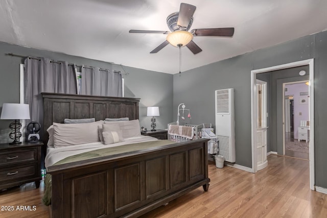 118 E 10th St, Casa Grande, AZ 85122 - bedroom featuring a heating unit, light wood-style floors, baseboards, and a ceiling fan