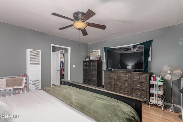 118 E 10th St, Casa Grande, AZ 85122 - bedroom with a heating unit, light wood finished floors, a walk in closet, and ceiling fan