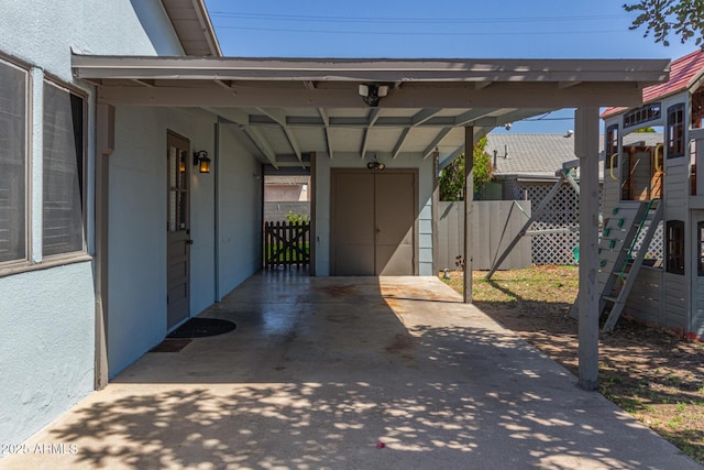 118 E 10th St, Casa Grande, AZ 85122 - view of car parking with fence, an attached carport, and a storage unit
