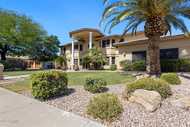 10434 N 44th St N, Phoenix, AZ 85028 - greek revival house with stucco siding, a front yard, and a balcony
