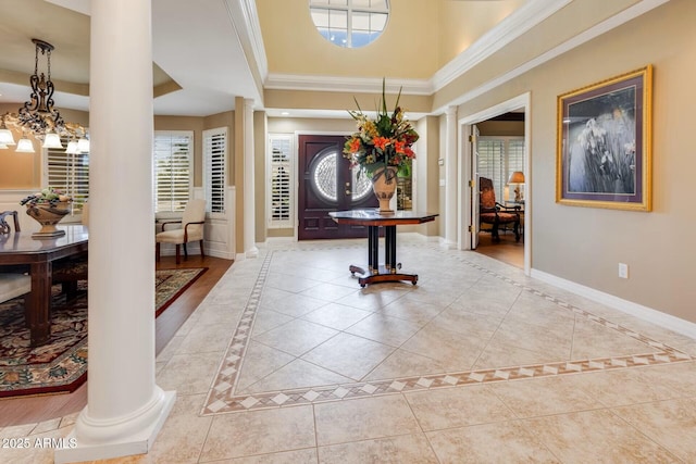 10434 N 44th St N, Phoenix, AZ 85028 - foyer featuring decorative columns, light tile patterned floors, inlaid floor details, baseboards, and a high ceiling