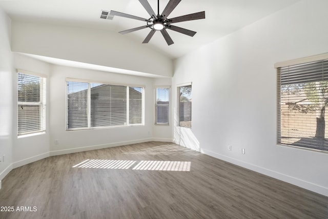 empty room with ceiling fan, hardwood / wood-style floors, and lofted ceiling