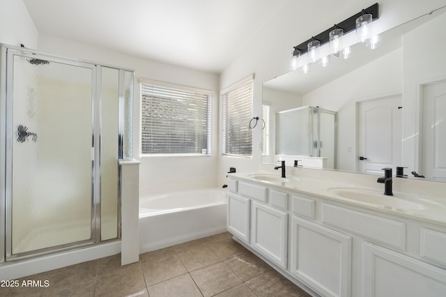 bathroom with tile patterned floors, vanity, independent shower and bath, and vaulted ceiling