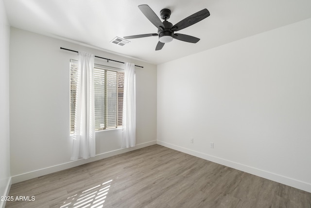 unfurnished room with light wood-type flooring and ceiling fan