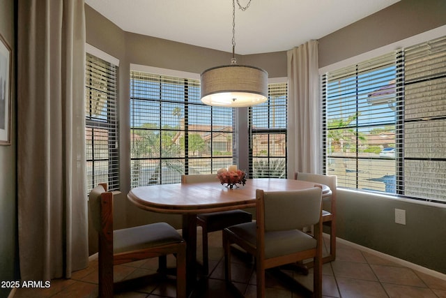 dining area with plenty of natural light and tile patterned floors