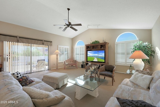 living room with vaulted ceiling, a healthy amount of sunlight, and light carpet