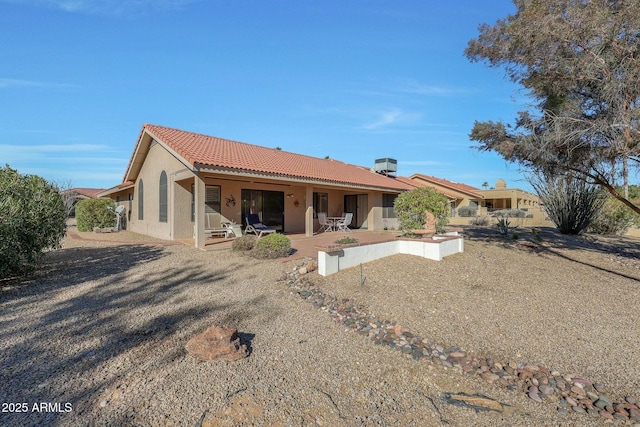 back of house featuring central AC unit and a patio