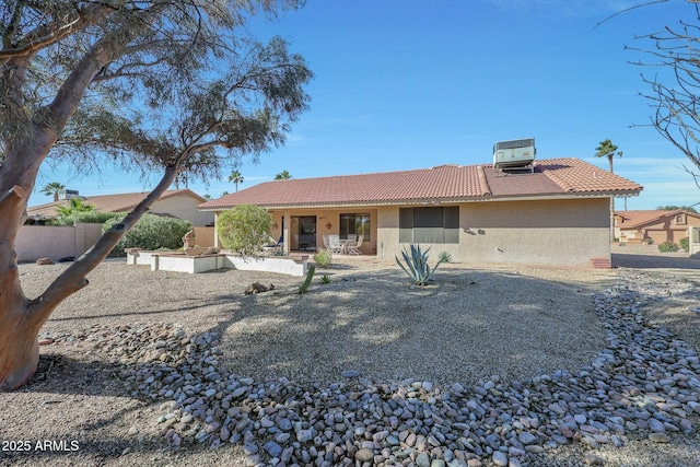 rear view of house with central AC unit