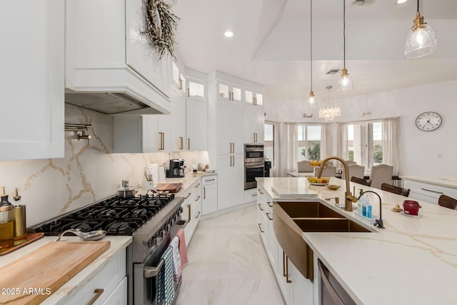 kitchen featuring a sink, recessed lighting, stainless steel appliances, white cabinets, and light stone countertops