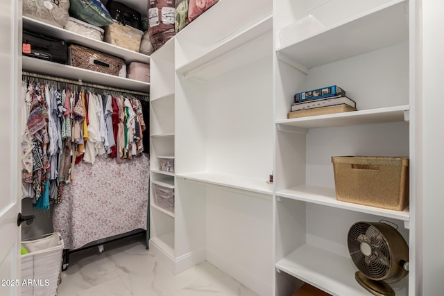 spacious closet with marble finish floor