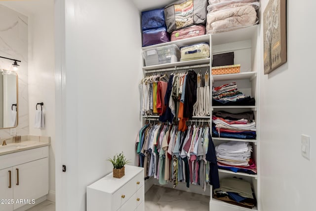 walk in closet featuring a sink