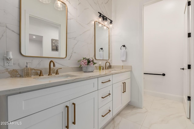 full bathroom with double vanity, marble finish floor, baseboards, and a sink