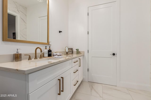 bathroom featuring vanity, baseboards, and marble finish floor