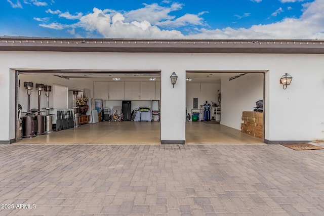 garage featuring decorative driveway