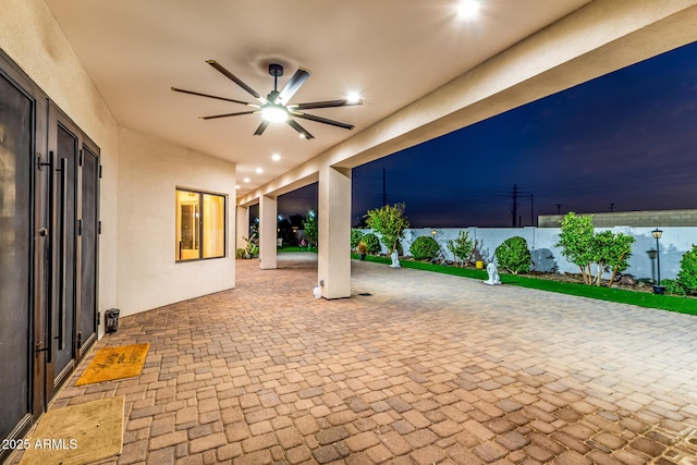 view of patio with a ceiling fan and fence