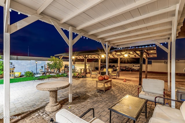 patio at twilight with outdoor dining space and an outdoor living space