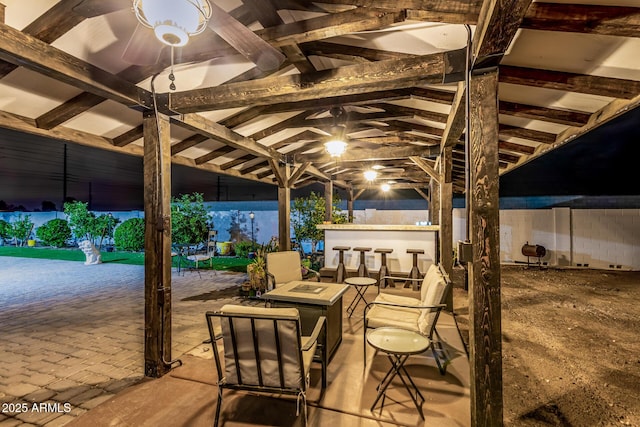 view of patio / terrace featuring outdoor dry bar and a fire pit