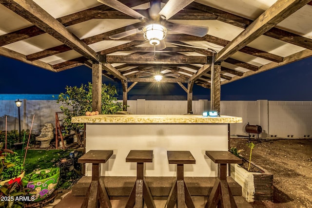 patio at twilight featuring fence