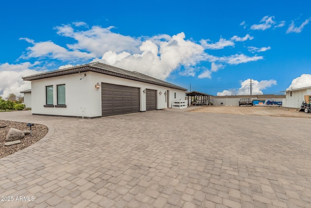 garage with decorative driveway