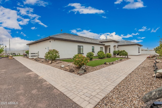 view of front of property with stucco siding and fence