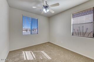 unfurnished room featuring baseboards and carpet