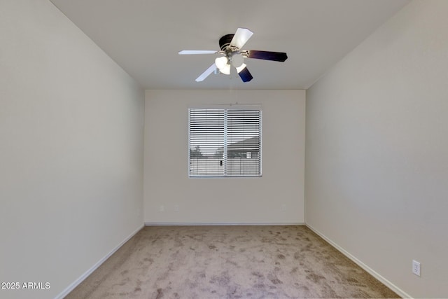 unfurnished room with baseboards, carpet flooring, and a ceiling fan