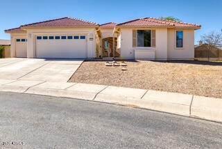 ranch-style home with concrete driveway, stucco siding, a garage, and a tile roof