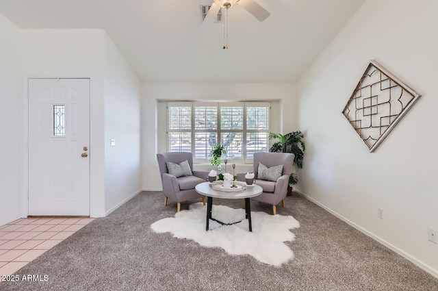 living area with vaulted ceiling, ceiling fan, and light carpet