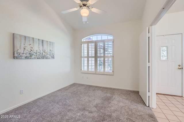 foyer entrance featuring ceiling fan and light colored carpet