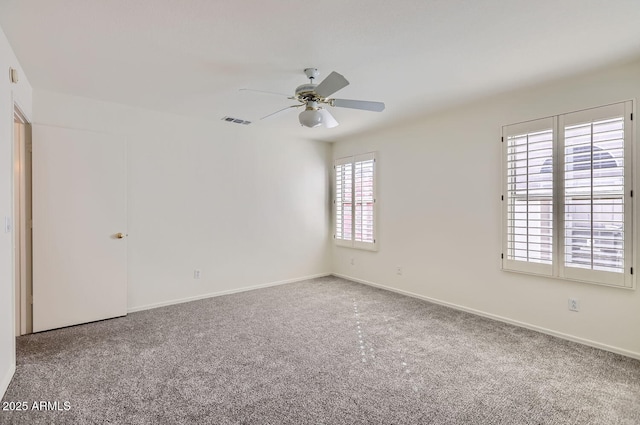 unfurnished room featuring ceiling fan, a healthy amount of sunlight, and carpet