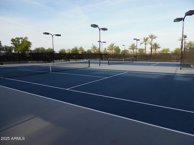 view of tennis court with basketball hoop