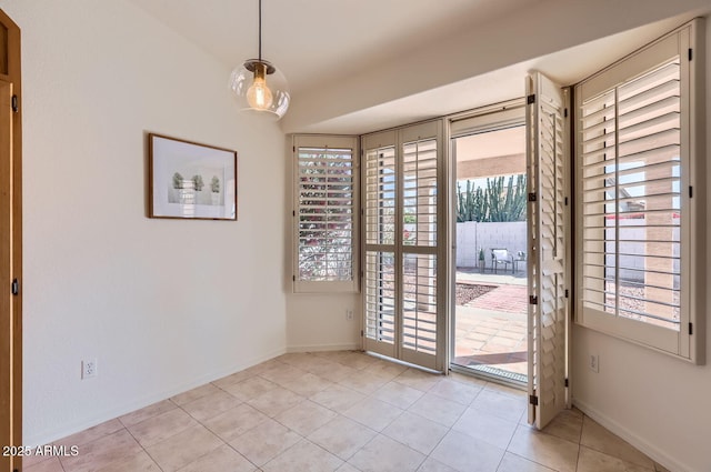 entryway with light tile patterned floors and a healthy amount of sunlight