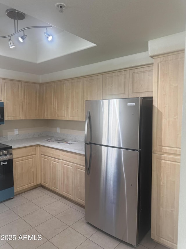 7575 E Indian Bend Rd Unit 1100, Scottsdale, AZ 85250 - kitchen featuring light brown cabinets, appliances with stainless steel finishes, light countertops, and light tile patterned floors