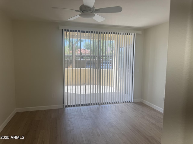 7575 E Indian Bend Rd Unit 1100, Scottsdale, AZ 85250 - empty room with a ceiling fan, wood finished floors, and baseboards